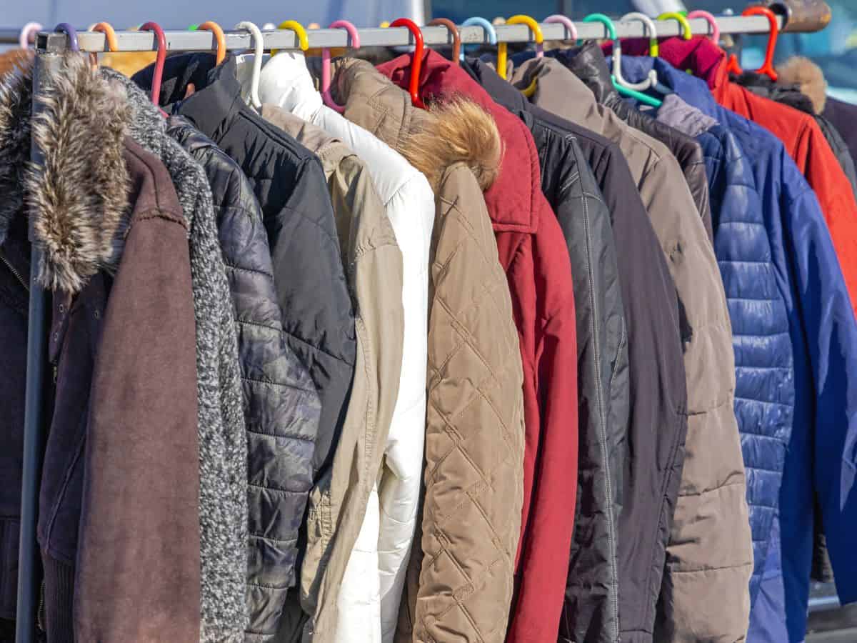 A row of different light jackets hanging on a rack, suitable for various weather conditions. A light jacket is an essential item to include in your California packing list for cooler evenings or unexpected weather changes.