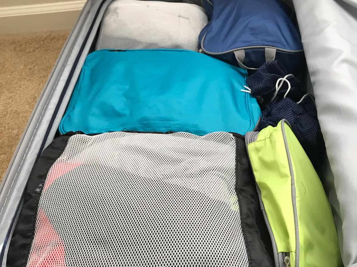  A suitcase filled with neatly organized packing cubes, demonstrating how packing cubes can help maximize space and organization in your California packing list.
