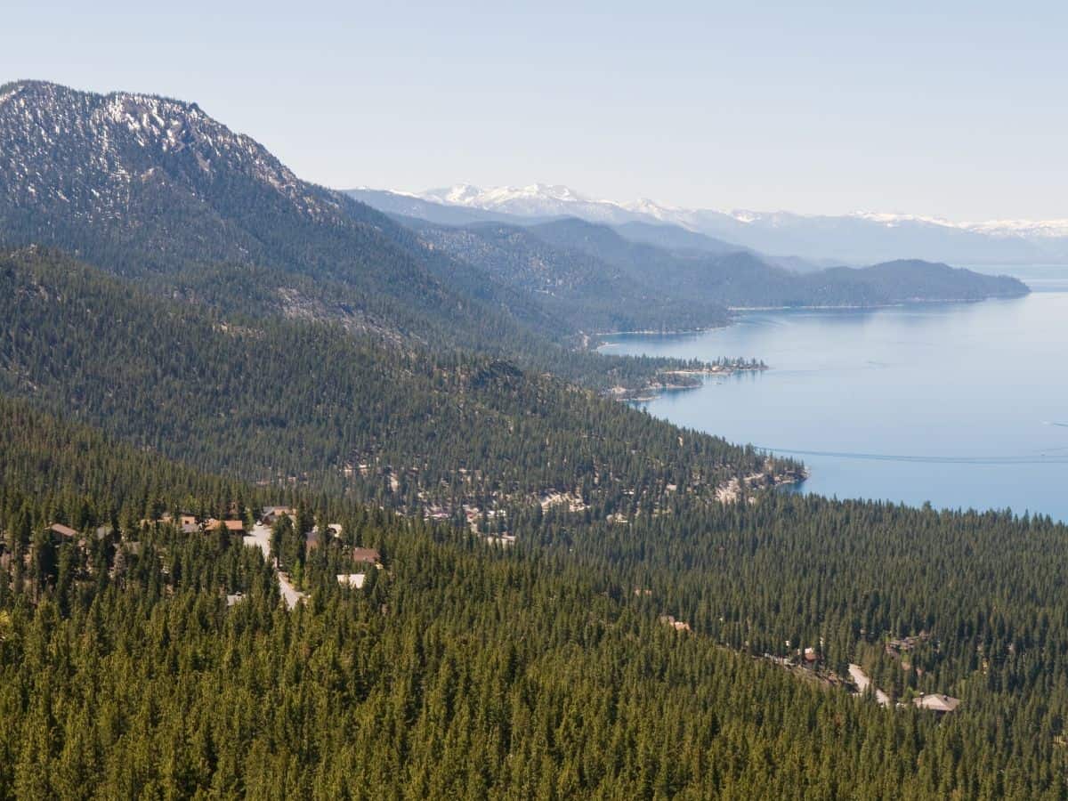 An expansive view from the Incline Flume Trail, with the green forest stretching out towards Lake Tahoe's shimmering blue waters. This gentle, easy trail is perfect for hikers looking to enjoy the natural beauty, making it one of the 11 Easy Lake Tahoe Hikes To Do.