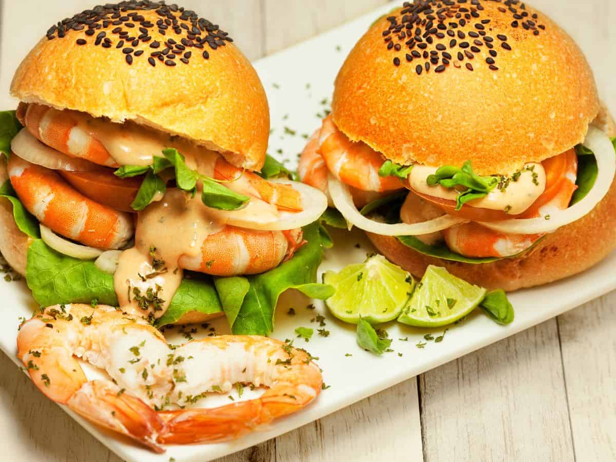  Fresh shrimp sandwiches filled with lettuce, onions, and a creamy sauce, showcasing the delightful combination of seafood and freshness at its finest, representing the Best Seafood In Southern California. These sandwiches are perfect for a casual yet flavorful seafood bite.