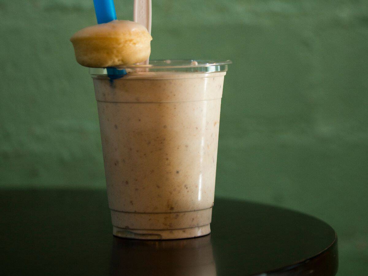 A delicious date shake topped with a mini donut served in a clear cup. Enjoying this famous treat is one of the must-try things to do in California in October, especially while exploring Palm Springs and the surrounding areas.