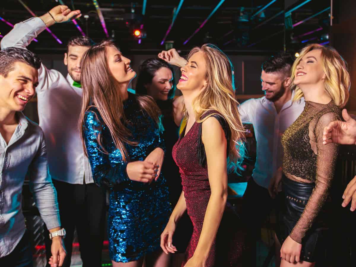 A group of friends dancing and enjoying a night out in a lively club, showcasing the dynamic nightlife in Los Angeles as part of the Seattle vs Los Angeles nightlife comparison.