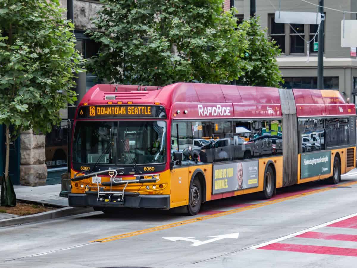 A RapidRide bus traveling through downtown Seattle, illustrating the efficiency of public transportation in Seattle compared to Los Angeles in the Seattle vs Los Angeles public transportation debate.