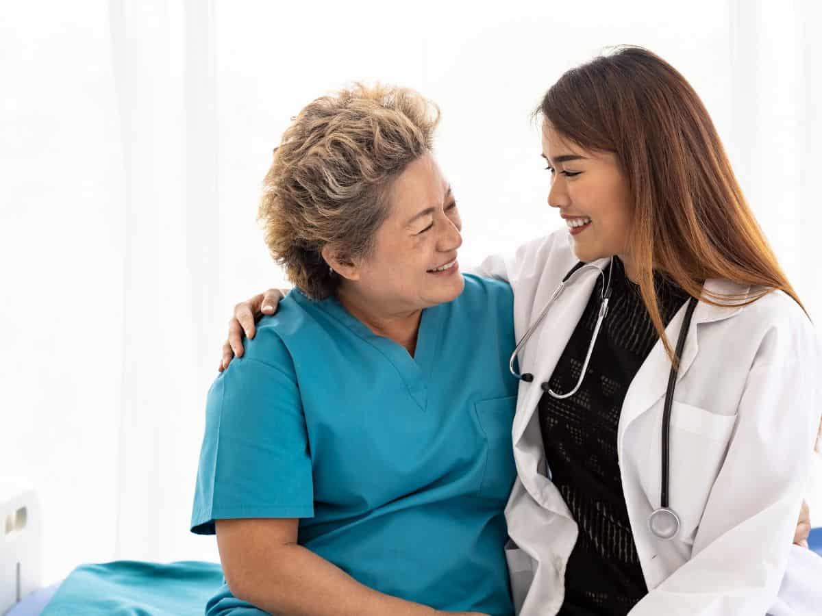 A group of people outside a modern building with a colorful Apple logo, representing healthcare access and quality in Denver vs San Francisco, with a nod to the tech-driven health solutions and innovations in the region.