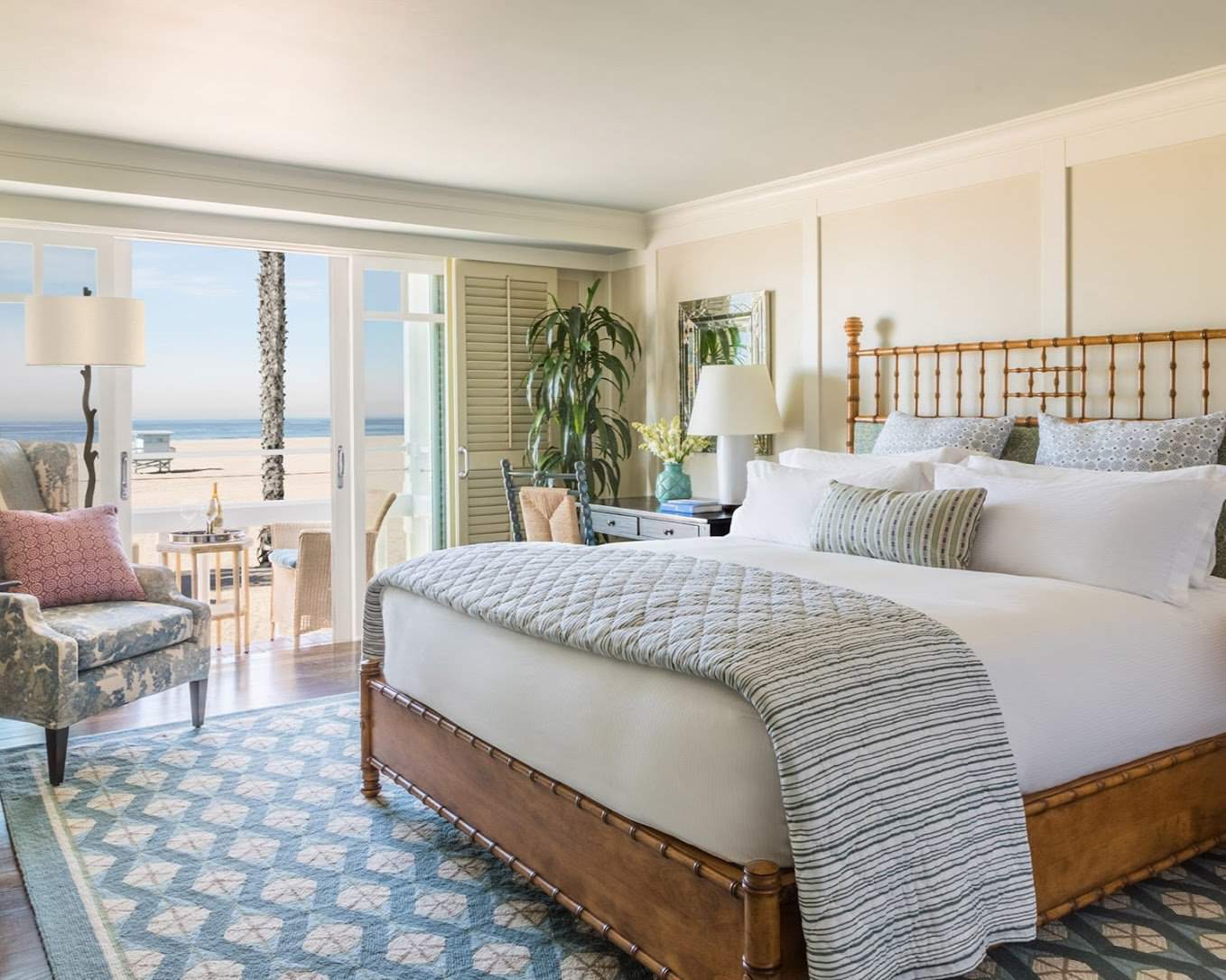 A luxurious beachfront room at Shutters on the Beach in Los Angeles, featuring a cozy bed, elegant decor, and a private balcony with stunning ocean views.