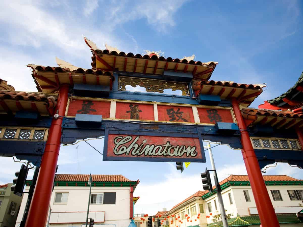 Vibrant red and blue traditional Chinese gateway in Los Angeles’ Chinatown, with intricate details and the word "Chinatown" displayed prominently in gold letters.