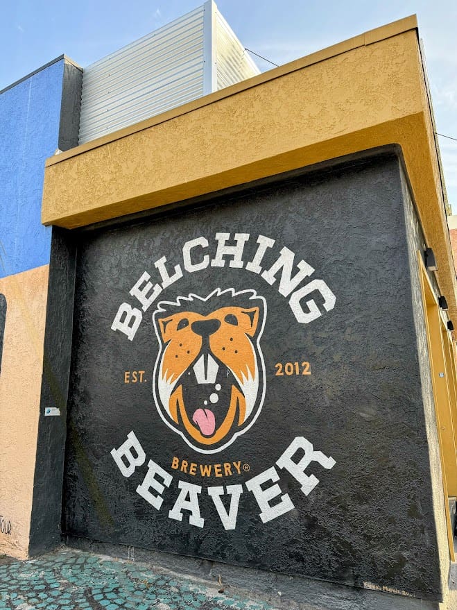 Mural of the Belching Beaver Brewery logo on a building wall, showcasing one of the best bars in North Park San Diego, with the establishment's name, an illustration of a beaver, and the founding year, 2012