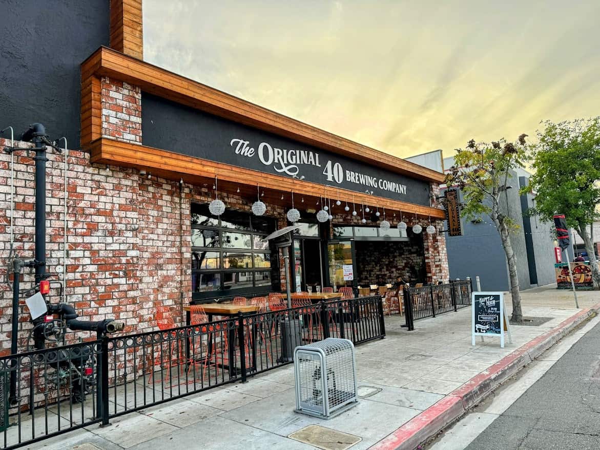 The Original 40 Brewing Company facade featuring exposed brick, wooden trim, and signage, a popular destination among the best bars in North Park San Diego, inviting with an open patio seating area