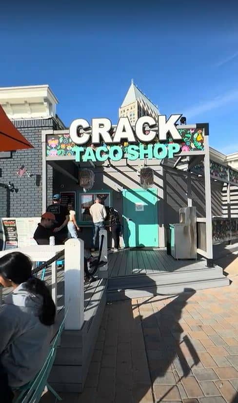 Vibrant entrance to the Crack Taco Shop with a large colorful sign