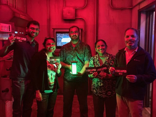 Kiran and I with my parents and brother posing after finishing an escape room game in San Jose