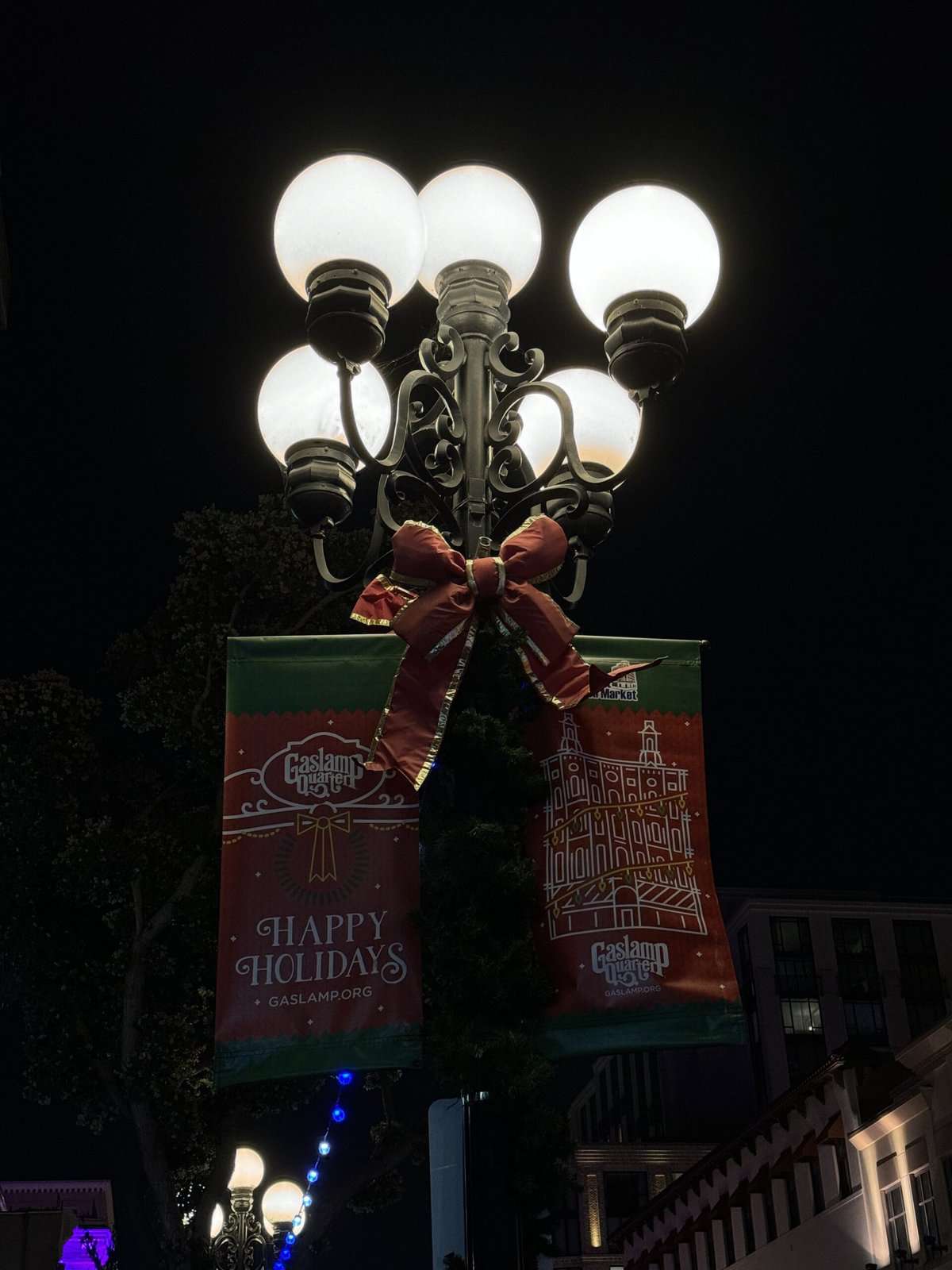 A decorated Gaslamp Quarter streetlamp with holiday greetings, adding to the festive atmosphere of the best things to do in Gaslamp Quarter San Diego.
