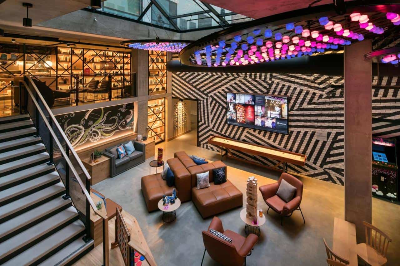 A funky hotel lounge with colorful lights and comfy couches, one of the best places to stay in Gaslamp Quarter San Diego.