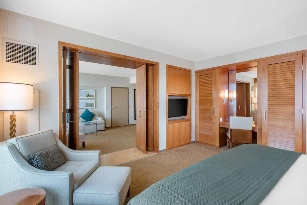 A spacious room with sleek furniture and a separate sitting area, great for travelers deciding where to stay in Gaslamp Quarter San Diego.