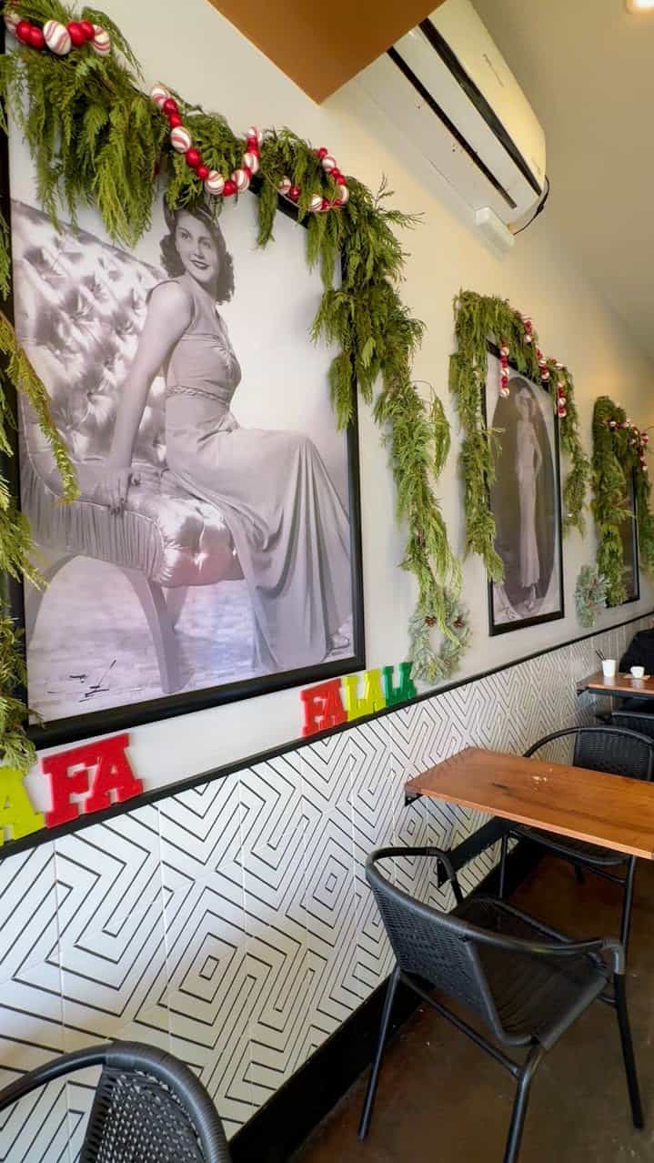 Inside Azucar in Ocean Beach San Diego, decorated with old-fashioned pictures and green decorations hanging around