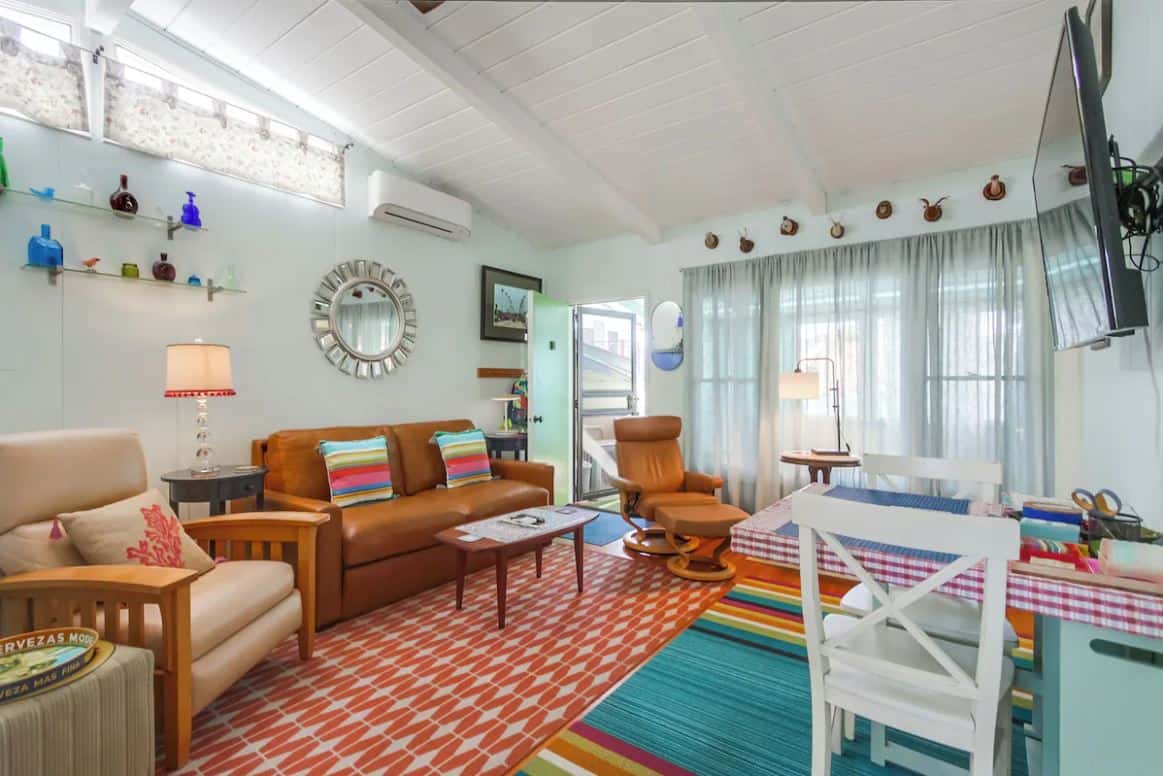 Colorful and eclectic living room at one of the best Airbnbs in Ocean Beach San Diego, featuring bright decor, a variety of seating options, and an array of decorative elements creating a lively and welcoming space