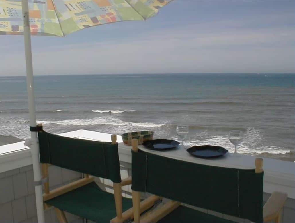 Breathtaking oceanfront dining setup at one of the best Airbnbs in Ocean Beach San Diego, offering a spectacular view of the sea from a high balcony