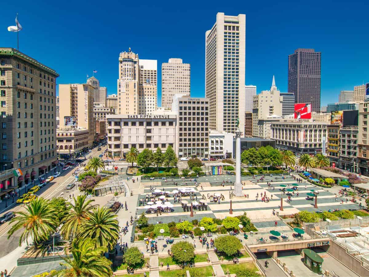 A bustling view of Union Square in San Francisco showcasing the dynamic urban environment. The square, framed by tall buildings and vibrant city life, is a popular destination for things to do in San Francisco, embodying the cultural and commercial hub of the city.