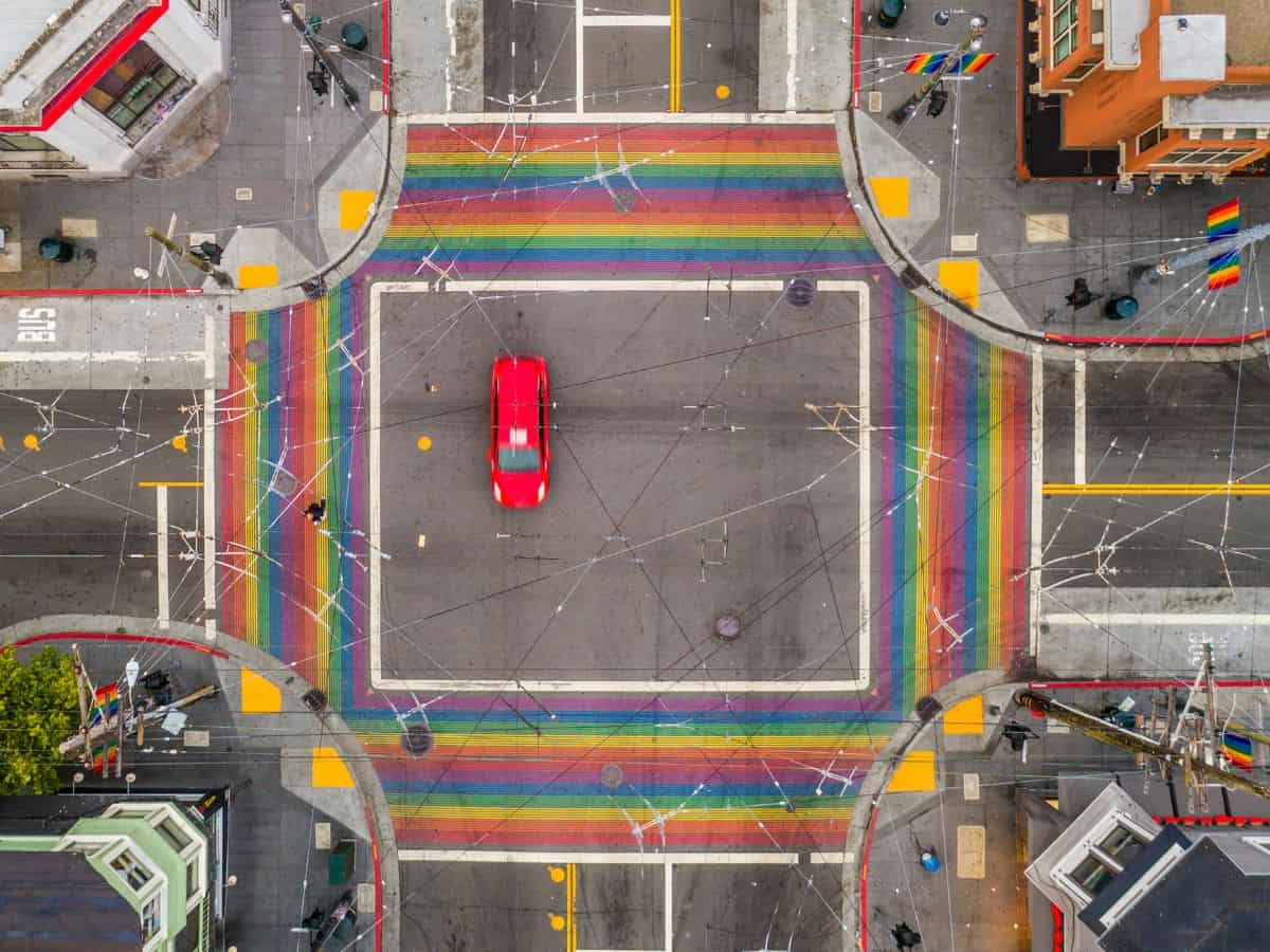 Aerial view of the Castro District in San Francisco, showing vibrant rainbow-colored crosswalks, capturing a unique urban scene that highlights the area's pride and cultural significance, an ideal destination for things to do in San Francisco.