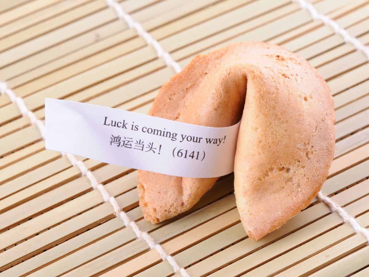 A close-up of a fortune cookie on a bamboo mat, symbolizing San Francisco's rich Chinese heritage. Visiting a fortune cookie factory is a unique cultural experience among the many things to do in San Francisco.