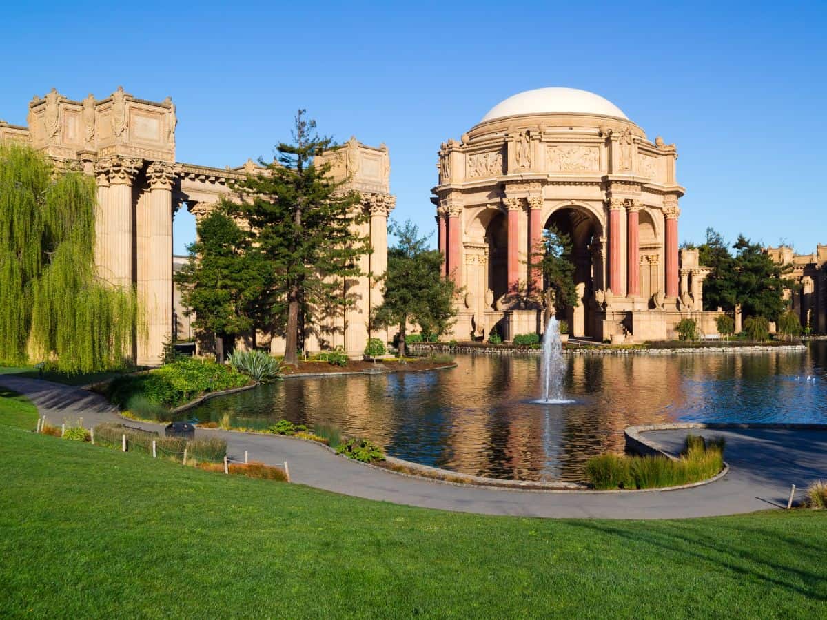 The majestic Palace of Fine Arts in San Francisco, featuring a classical dome and columns reflecting in a tranquil pond. Visiting this architectural gem is a favorite for both locals and tourists among the cultural things to do in San Francisco.