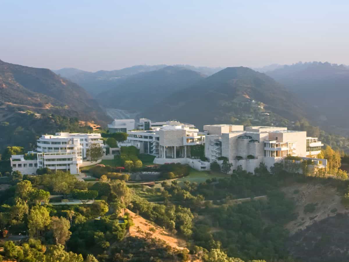 Aerial view of the Getty Center perched in the Santa Monica Mountains, surrounded by lush gardens and modern architecture, a top cultural thing to do in Los Angeles.