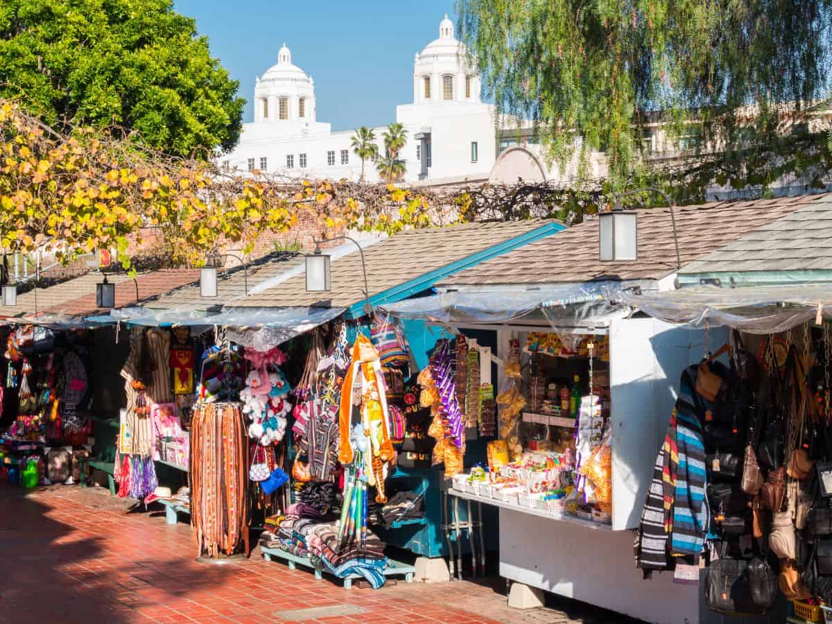 Olvera Street market in Los Angeles, bustling with activity and colorful stalls selling traditional Mexican crafts and snacks, a historic and cultural thing to do in Los Angeles.