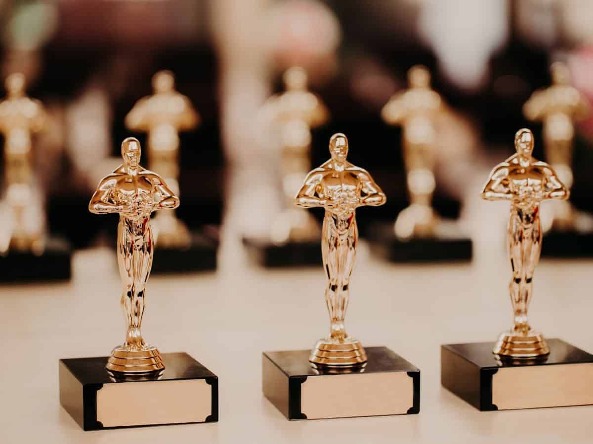A row of Oscar statuettes on display, representing the pinnacle of cinematic achievement.