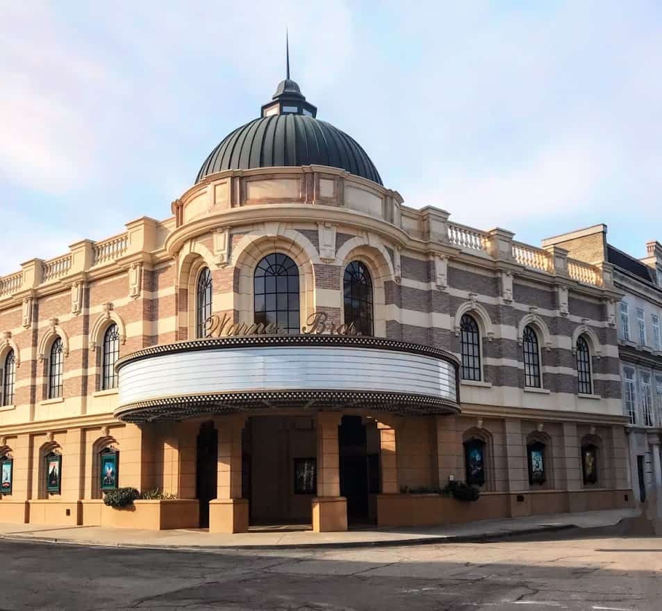 Entrance to Warner Bros. Studio showcasing the elegant facade of the main building with its iconic logo, inviting visitors to explore behind-the-scenes of movie magic, a fascinating thing to do in Los Angeles.