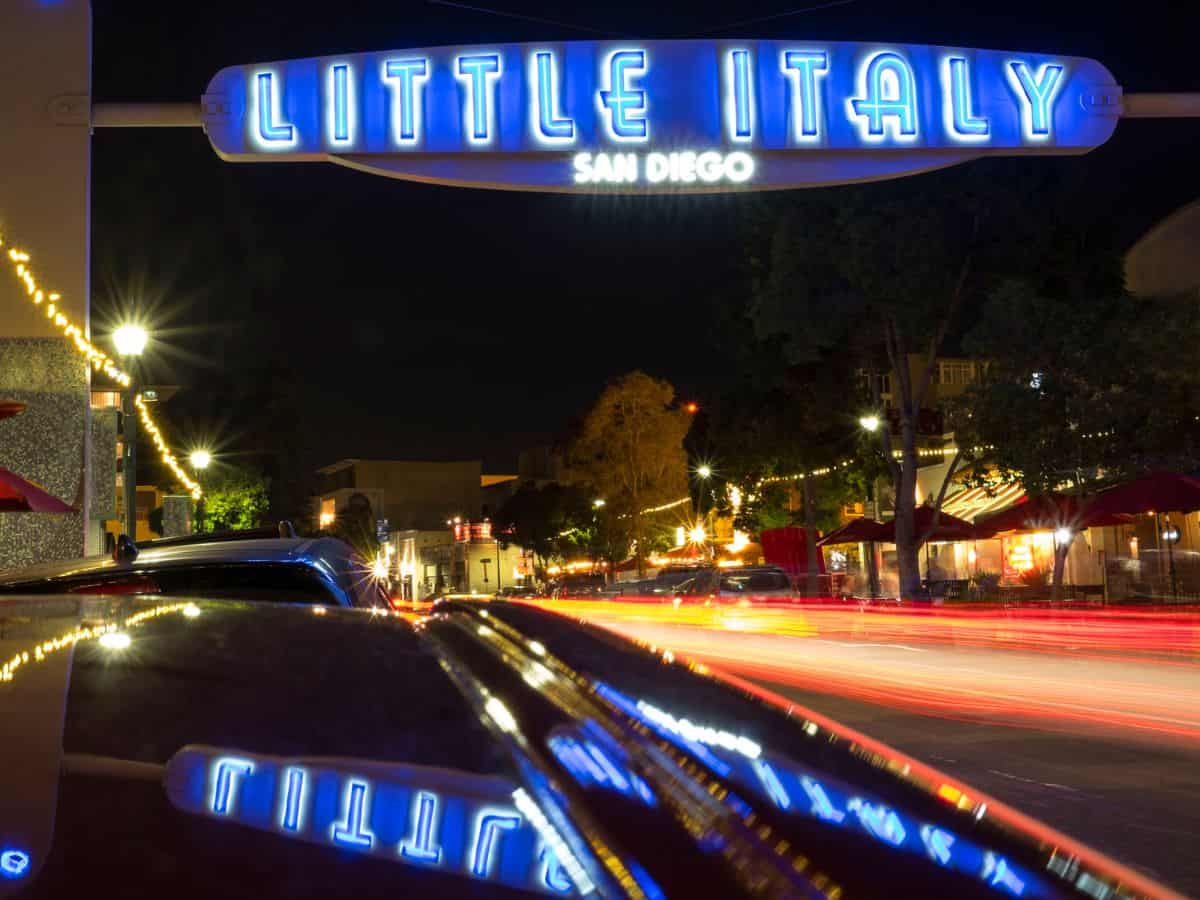 Neon-lit Little Italy sign at night, marking one of the best neighborhoods to explore for food and culture in San Diego.