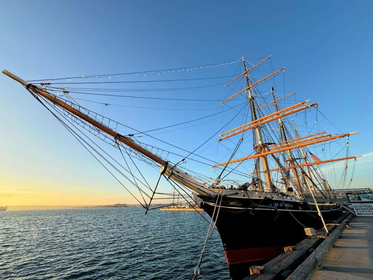 The historic tall ship Star of India docked at the Maritime Museum of San Diego. Exploring this ship and the other exhibits at the museum is one of the educational and intriguing things to do in San Diego, offering a glimpse into maritime history against the backdrop of a golden sunset.