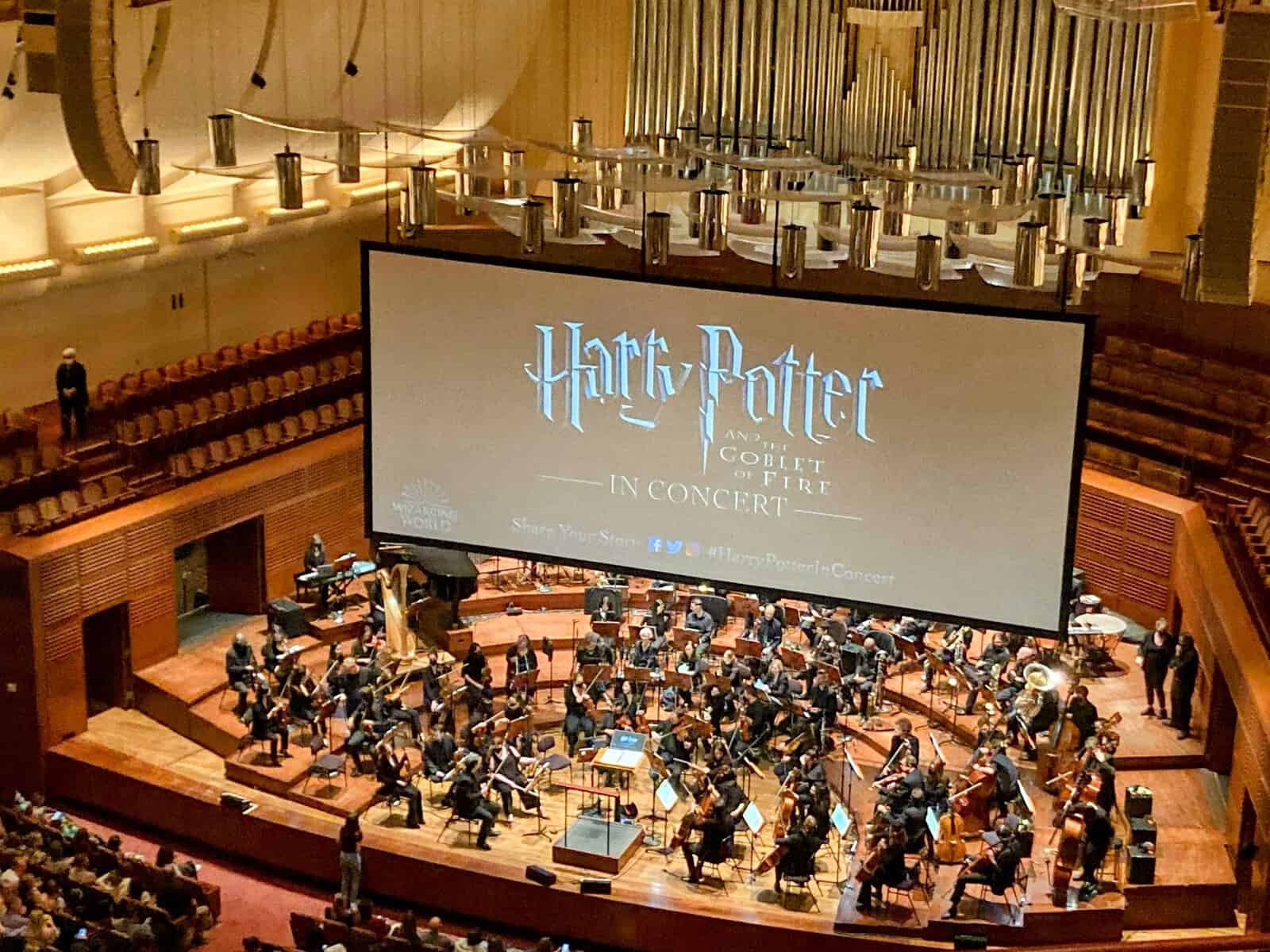 Audience view of a live symphony orchestra performing the "Harry Potter and the Goblet of Fire" film score at a concert hall in San Francisco. Attending this concert is a magical thing to do in San Francisco, highlighting the city's vibrant cultural scene.