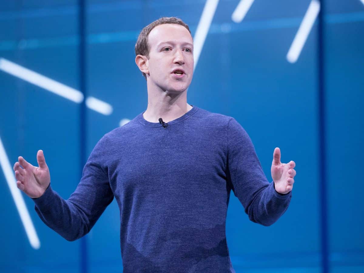 A speaker gesturing on a stage with confidence, emphasizing leadership and success. California has the highest number of millionaires in the U.S., which contributes to higher demand for luxury goods and real estate, explaining why it is so expensive.