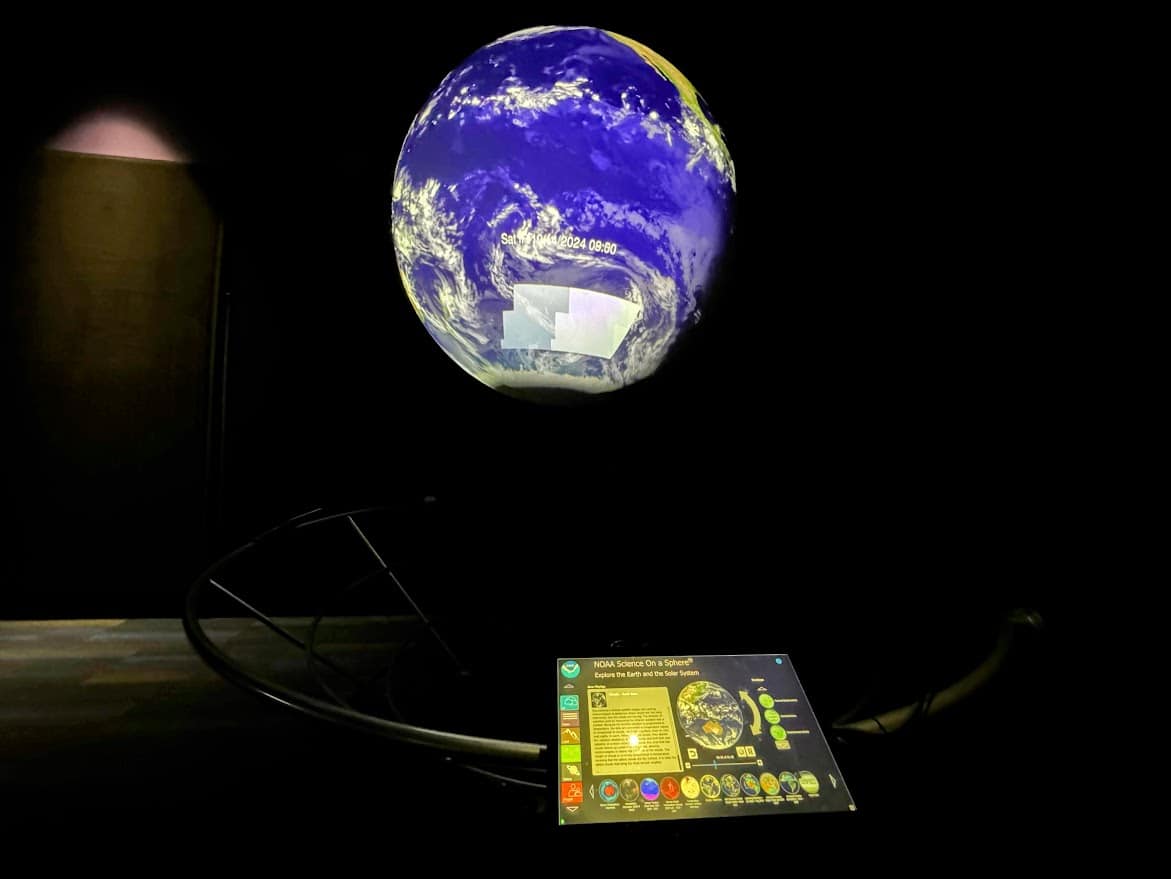 A 6-foot Earth sphere at The Tech Interactive, projecting real-time satellite data to visualize Earth’s environment dynamically.