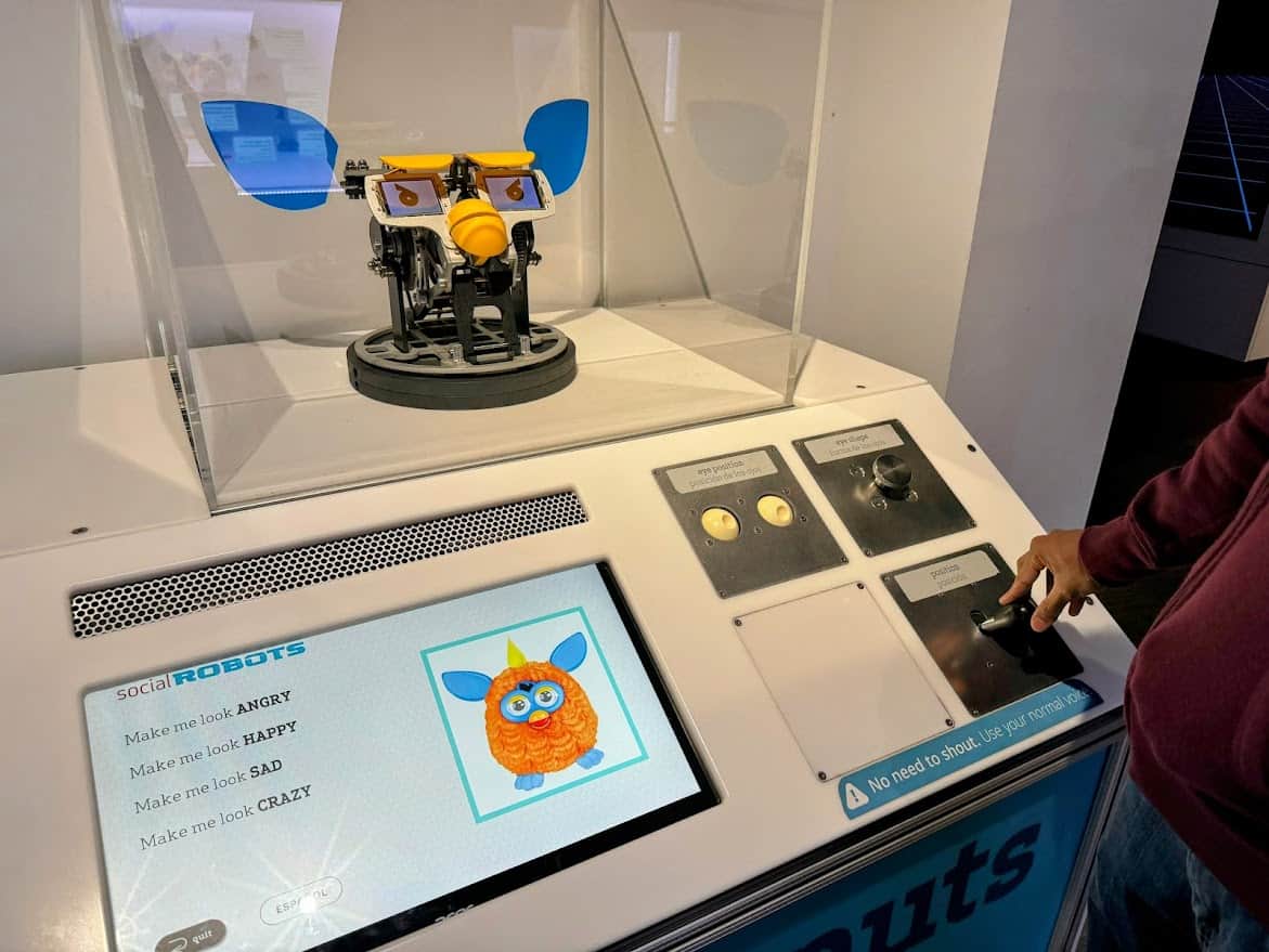 An interactive Furby display at The Tech Interactive, where Kiran uses the knobs to change Furby’s eyes and emotions. 