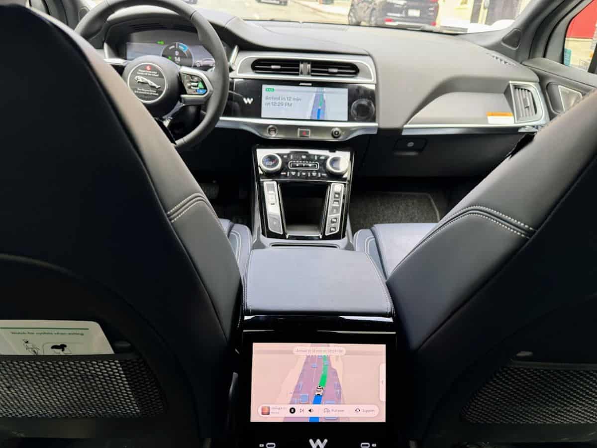 The interior of a modern car featuring sleek leather seats, a digital dashboard, and a navigation system displaying a route. The advanced technology and luxurious design reflect the influence of the tech industry in San Francisco, raising the question, Why Is San Francisco So Expensive, as the city's high-tech innovations and affluent lifestyle drive up the cost of living.