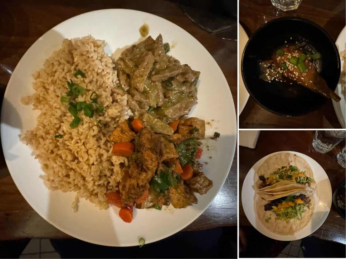 A collection of vegan dishes from one of the 10 Vegan Spots in San Jose. The main image features a plate with brown rice garnished with green onions, creamy green curry with vegetables, and a flavorful stir-fry. The top-right inset shows a small bowl of roasted eggplant topped with sesame seeds and scallions, while the bottom-right inset highlights two soft tacos filled with black beans, lettuce, and vegan cheese, served on a rustic tortilla.