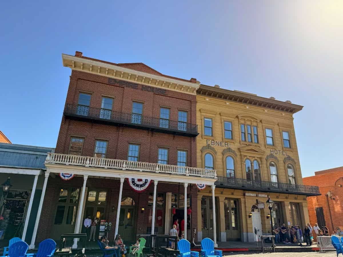 The historic Ebner Hotel and Empire House in Old Sacramento stand side by side with people relaxing outside, highlighting a popular stop on the 32 Things To Do In Sacramento list.