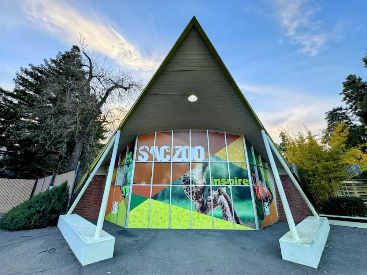The entrance to the Sacramento Zoo with colorful graphics and the word "Inspire" across the glass windows, a family-friendly highlight from 32 Things To Do In Sacramento.
