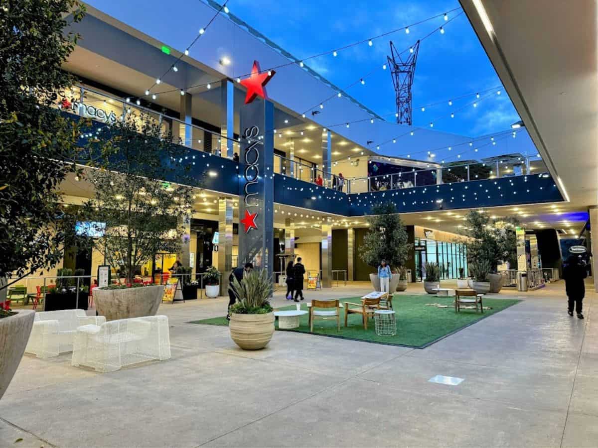An open-air shopping center with Macy’s, string lights, and casual seating, featured as one of the retail stops in the 32 Things To Do In Sacramento.