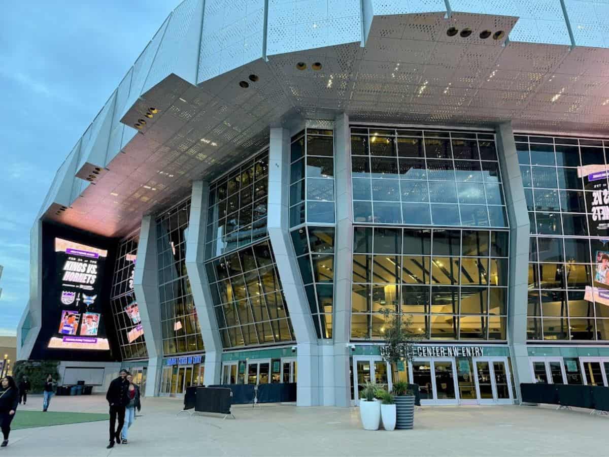 Golden 1 Center’s futuristic glass exterior with digital screens promoting an NBA game, a major venue on the 32 Things To Do In Sacramento list.