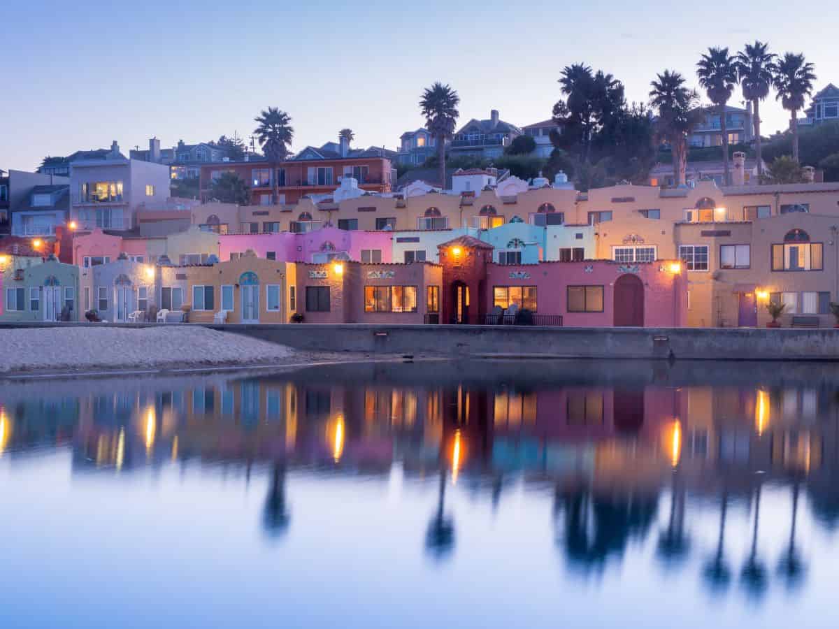 Capitola’s colorful beachfront homes, reflecting on calm waters at twilight, strongly resemble the vibrant villages of Cinque Terre, Italy.
