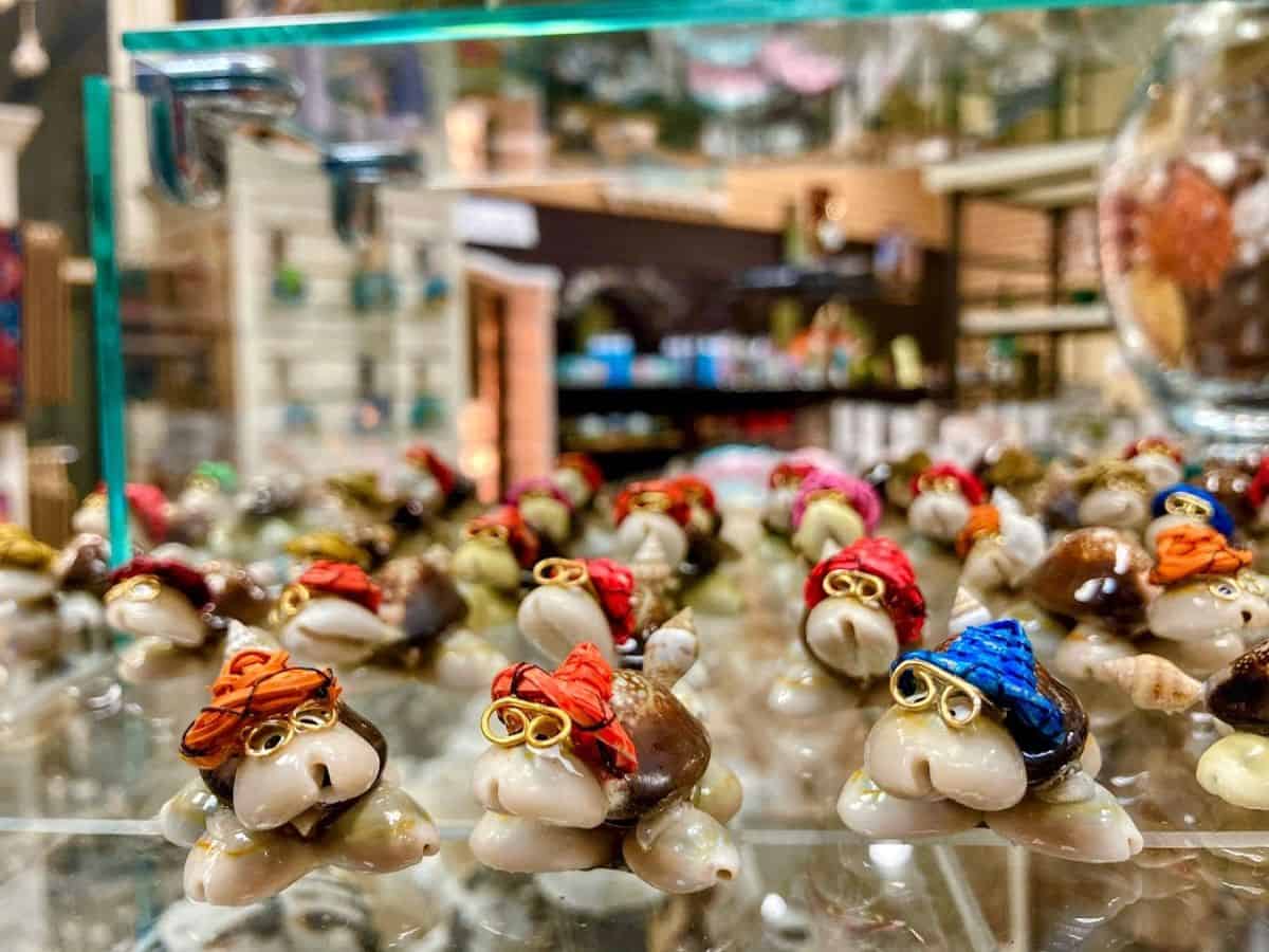 A display of tiny, handcrafted turtle souvenirs wearing colorful hats sits inside a charming Santa Cruz gift shop. Picking up a unique memento from a local shop is one of the best 21 Things to Do in Santa Cruz.