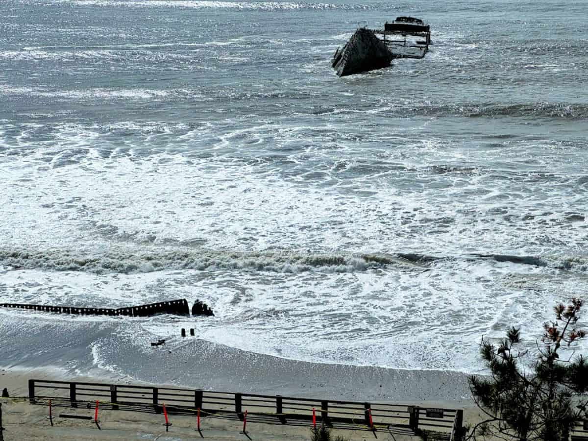 The remains of the SS Palo Alto, a partially sunken shipwreck, sit just offshore as waves crash against it. Visiting this eerie yet fascinating piece of history is one of the 21 Things to Do in Santa Cruz.