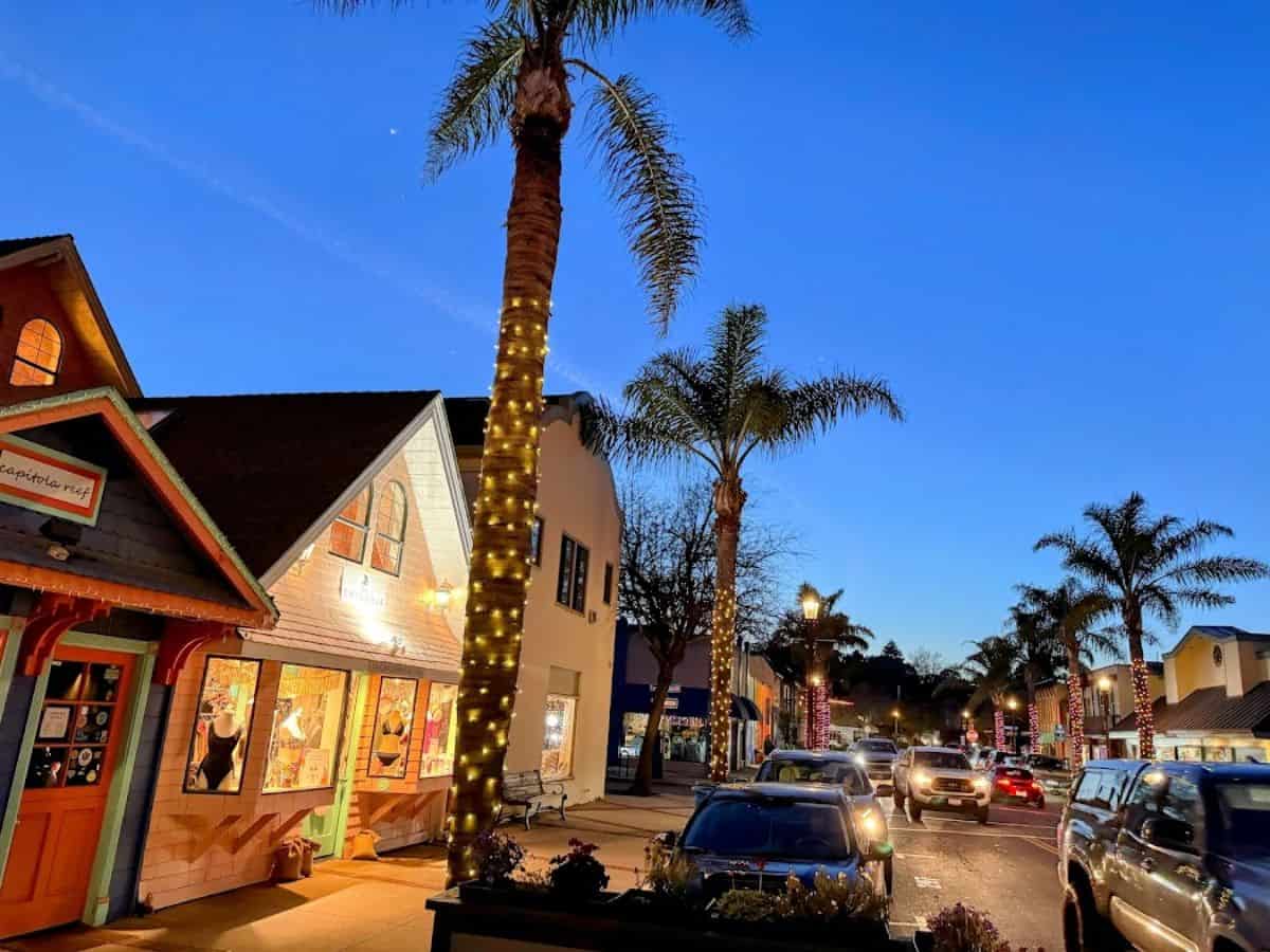 The charming streets of Capitola Village are lit up at dusk, with festive lights and colorful storefronts. Shopping and strolling through this picturesque beach town is one of the top 21 Things to Do in Santa Cruz.
