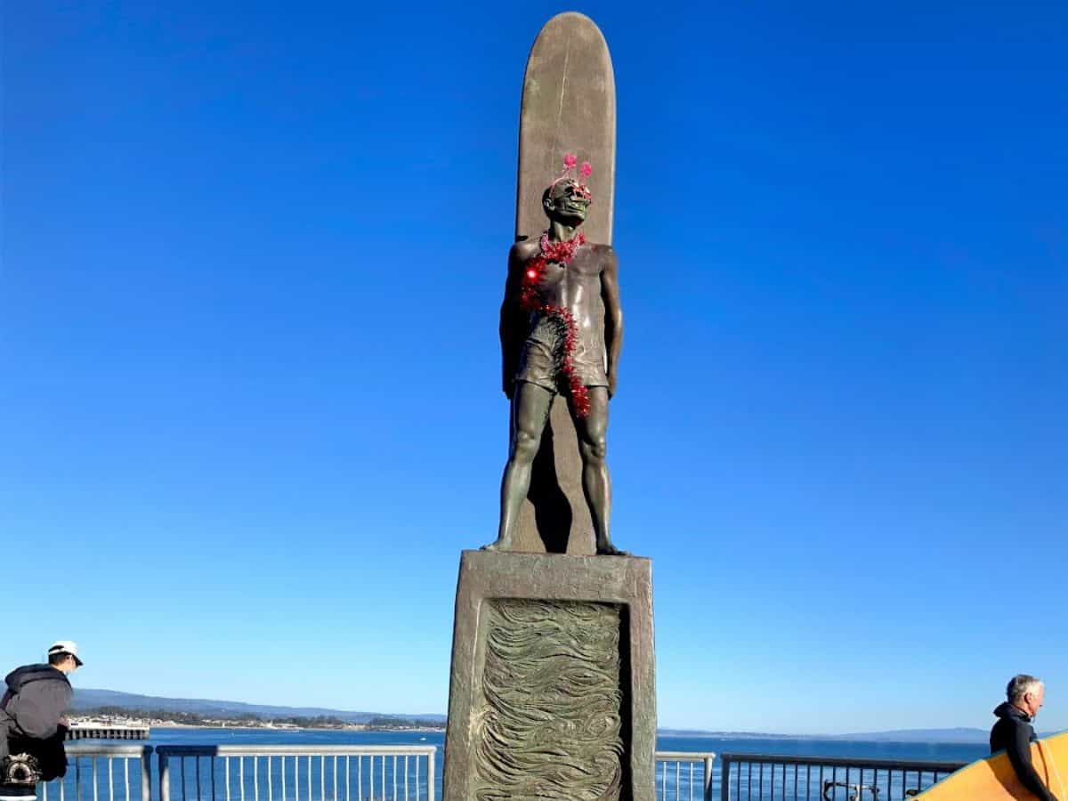 The “To Honor Surfing” statue stands tall, overlooking the ocean, with surfers catching waves in the background. Capturing a photo of this iconic landmark is one of the 21 Things to Do in Santa Cruz.