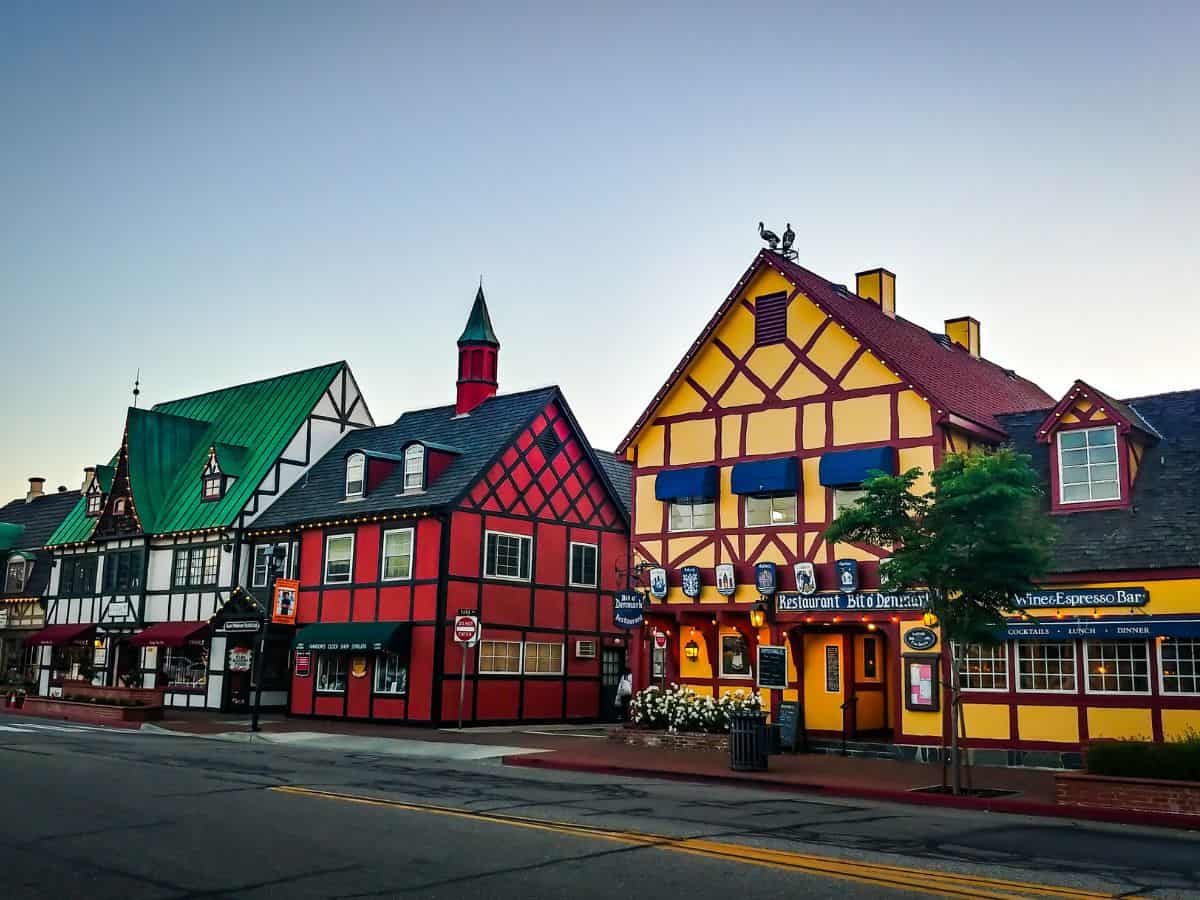Solvang’s charming half-timbered buildings, vibrant colors, and European-style streets mirror the historic beauty of Ribe, Denmark.