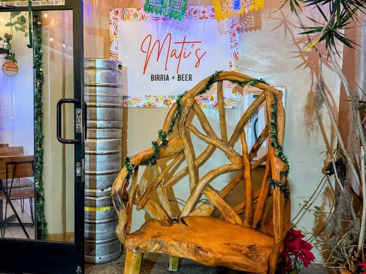 Inside Matis, a charming inclusion among the best restaurants in Pacific Beach San Diego, with colorful papel picado banners overhead and a rustic wooden chair in the foreground