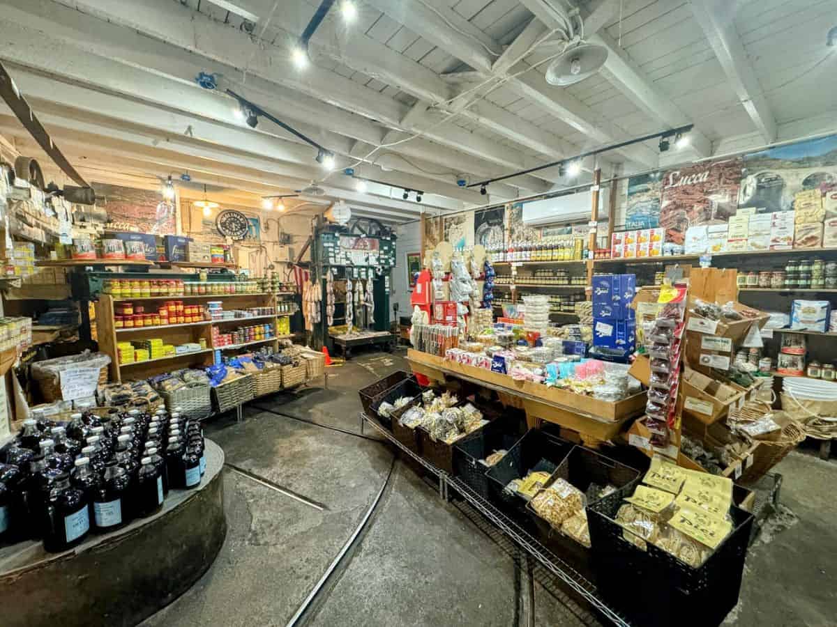 A rustic interior packed with shelves of pasta, canned goods, olive oils, and Italian specialties at Napa Valley Olive Oil Manufacturing Co.—a flavorful and authentic experience in St. Helena.