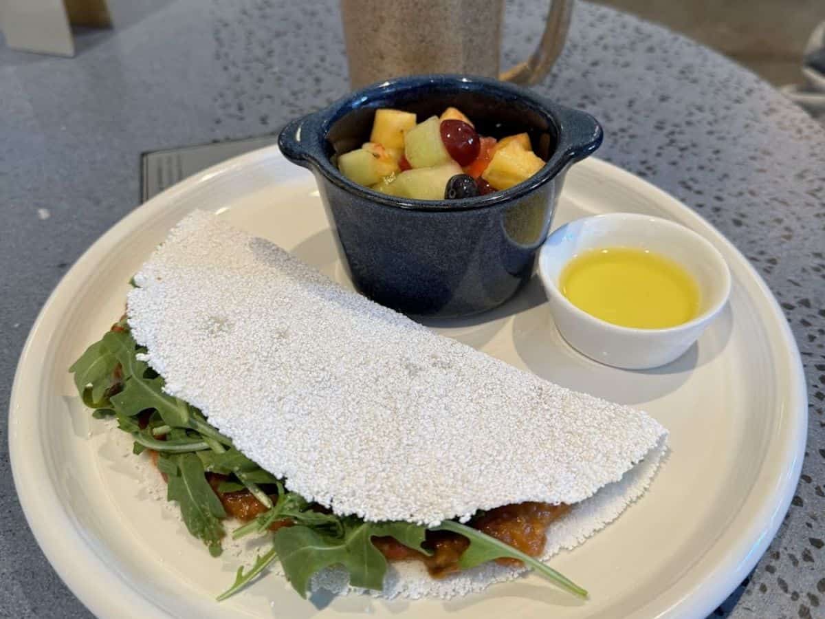 A plate of Brazilian pão de queijo, açaí bowl, and fresh juices served at Cafe de Casa, listed among the Best Spots to eat in San Francisco.