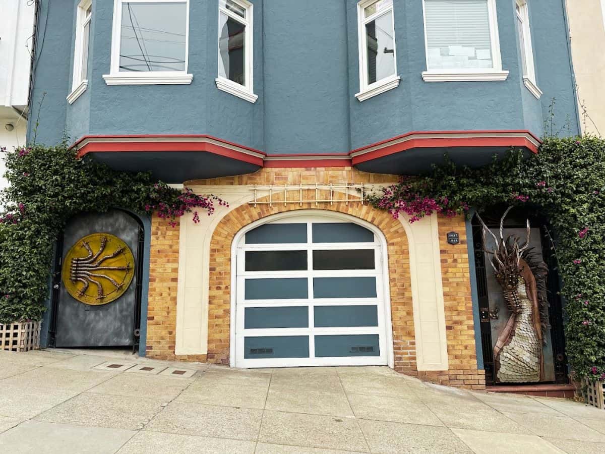 Decorative residential doors on Leavenworth Street near Fisherman’s Wharf, one featuring a serpent design and another with a dragon figure